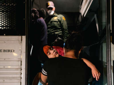 A migrant mother and son board a patrol bus to be taken to a border patrol processing facility after crossing the Rio Grande into the U.S. on June 21, 2021, in La Joya, Texas.