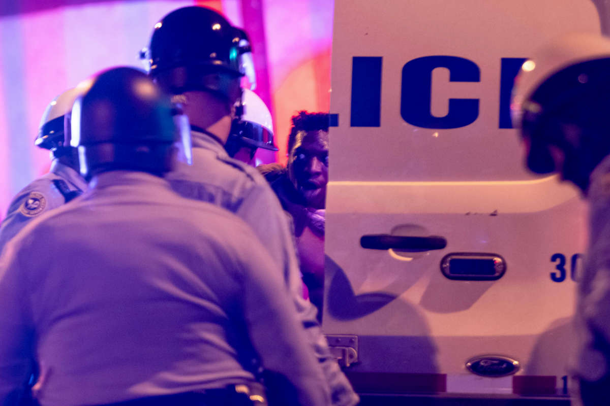 Police arrest a protester in West Philadelphia on October 27, 2020, during a demonstration against the fatal shooting of 27-year-old Walter Wallace, a Black man, by police. Wallace's family said he suffered mental health issues.