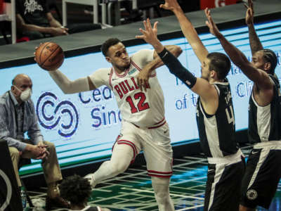 Chicago Bulls forward Daniel Gafford saves a loose ball while defended by Los Angeles Clippers center Ivica Zubac and LA Clippers forward Kawhi Leonard as owner Steve Ballmer looks on at Staples Center in Los Angeles, California, on January 10, 2021.