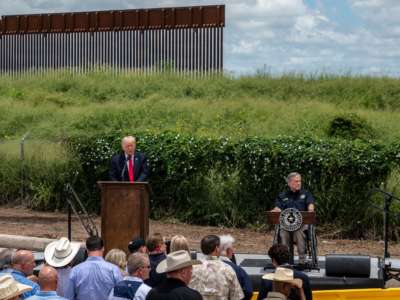 Former President Donald Trump speaks, flanked by Texas Gov. Greg Abbott, during a visit to the border wall near Pharr, Texas, on June 30, 2021.