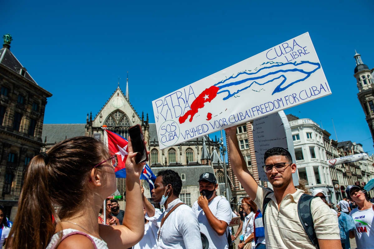 A man is holding a sign during the demonstration in support of Cuba organized in Amsterdam on July 17, 2021.