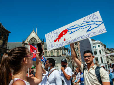 A man is holding a sign during the demonstration in support of Cuba organized in Amsterdam on July 17, 2021.
