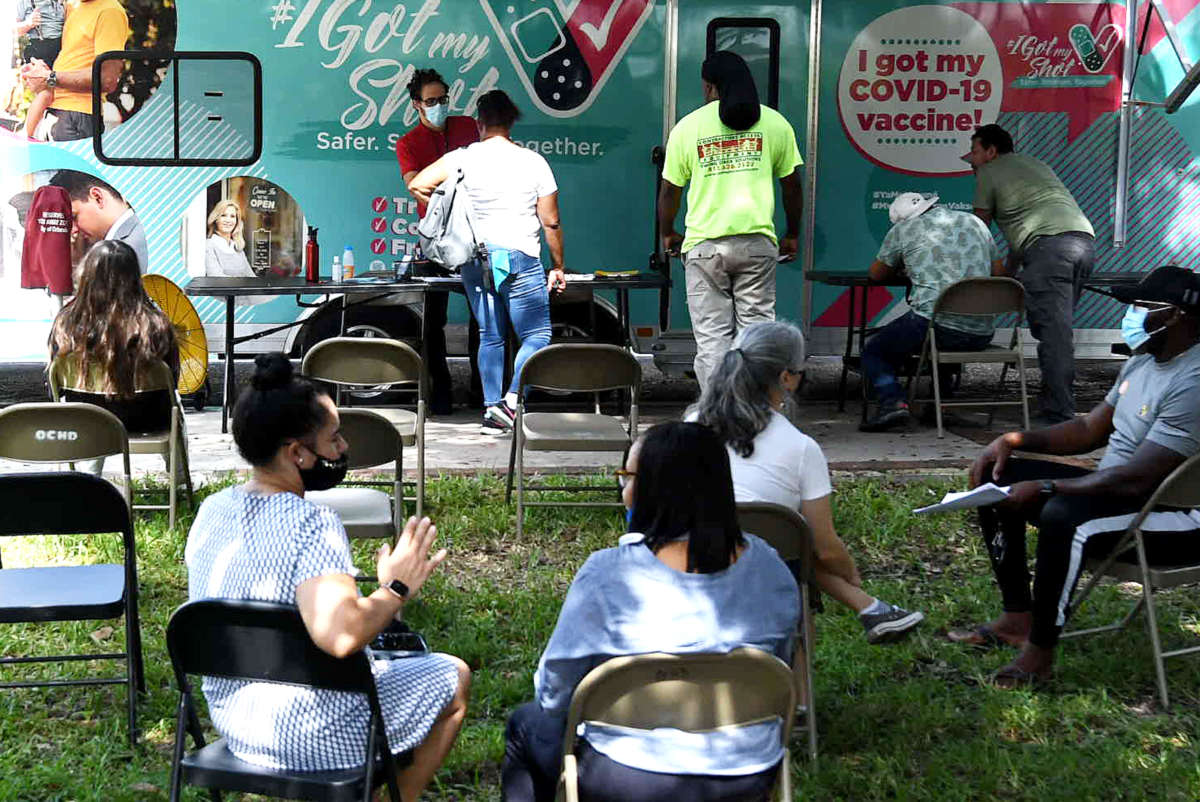 People wait in the observation area at a mobile COVID-19 vaccination site in Orlando, Florida, on July 21, 2021.
