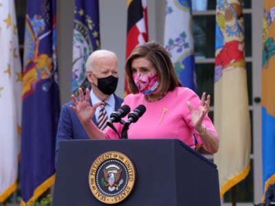 Speaker of the House Rep. Nancy Pelosi speaks as President Joe Biden listens during an event on the American Rescue Plan in the Rose Garden of the White House on March 12, 2021, in Washington, D.C.