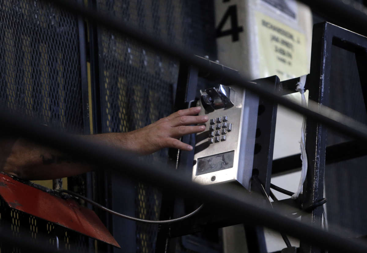 An incarcerated person makes a phone call from his cell in East Block of death row at San Quentin State Prison on December 29, 2015, in San Quentin, California.