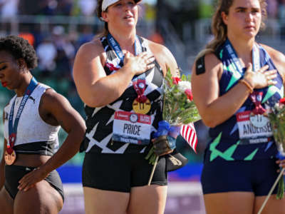 Gwendolyn Berry (left), turns away from U.S. flag during the U.S. national anthem on June 26, 2021 in Eugene, Oregon. In 2019, the USOPC reprimanded Berry after her demonstration on the podium at the Lima Pan American Games.