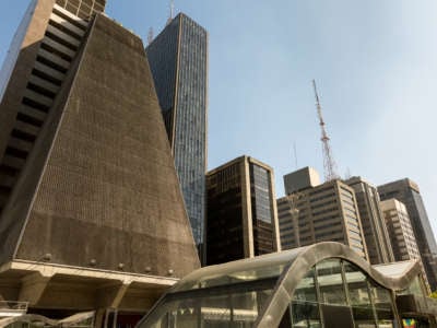 There is now a growing movement in Brazil to reclaim sacred objects and collections from museums, such as the São Paulo Cultural Center (CCSP), the triangular building that appears on the left in this photo of São Paulo, Brazil.