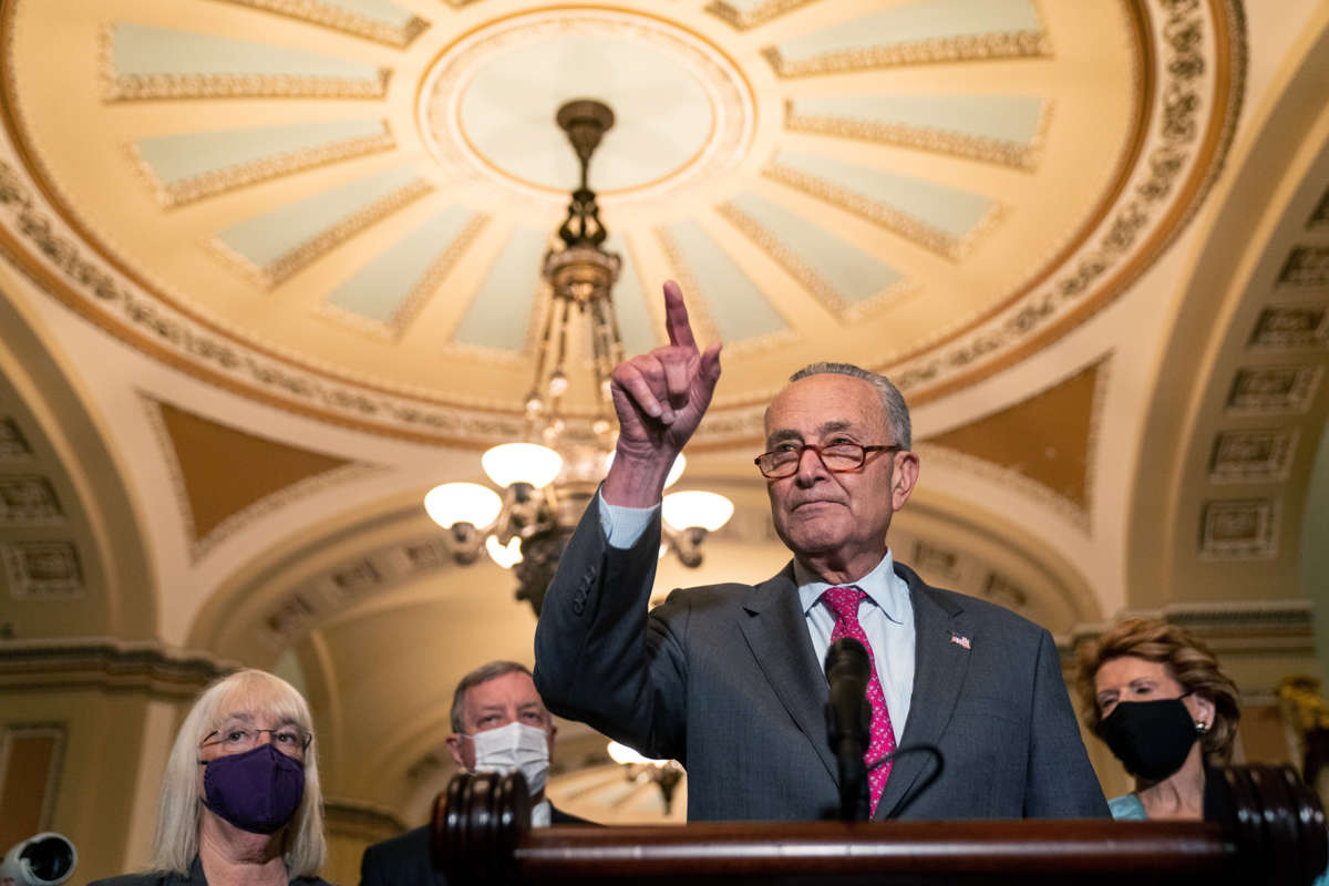 Chuck Schumer points at the ceiling