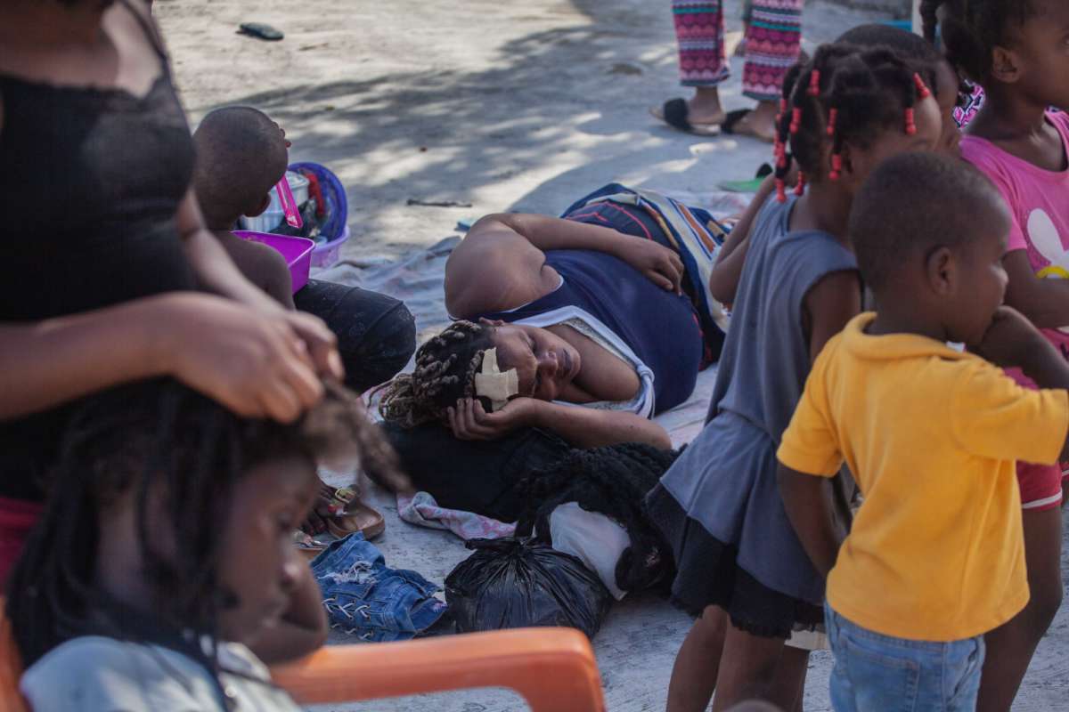 An injured woman lays on the ground