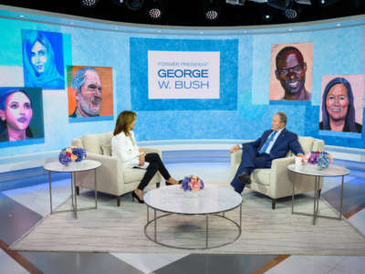 George W. Bush is interviewed while surrounded by his "paintings"