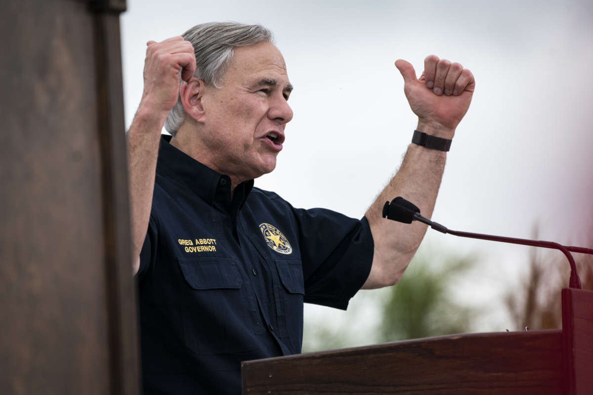 Greg Abbott pumps his arms at a rally