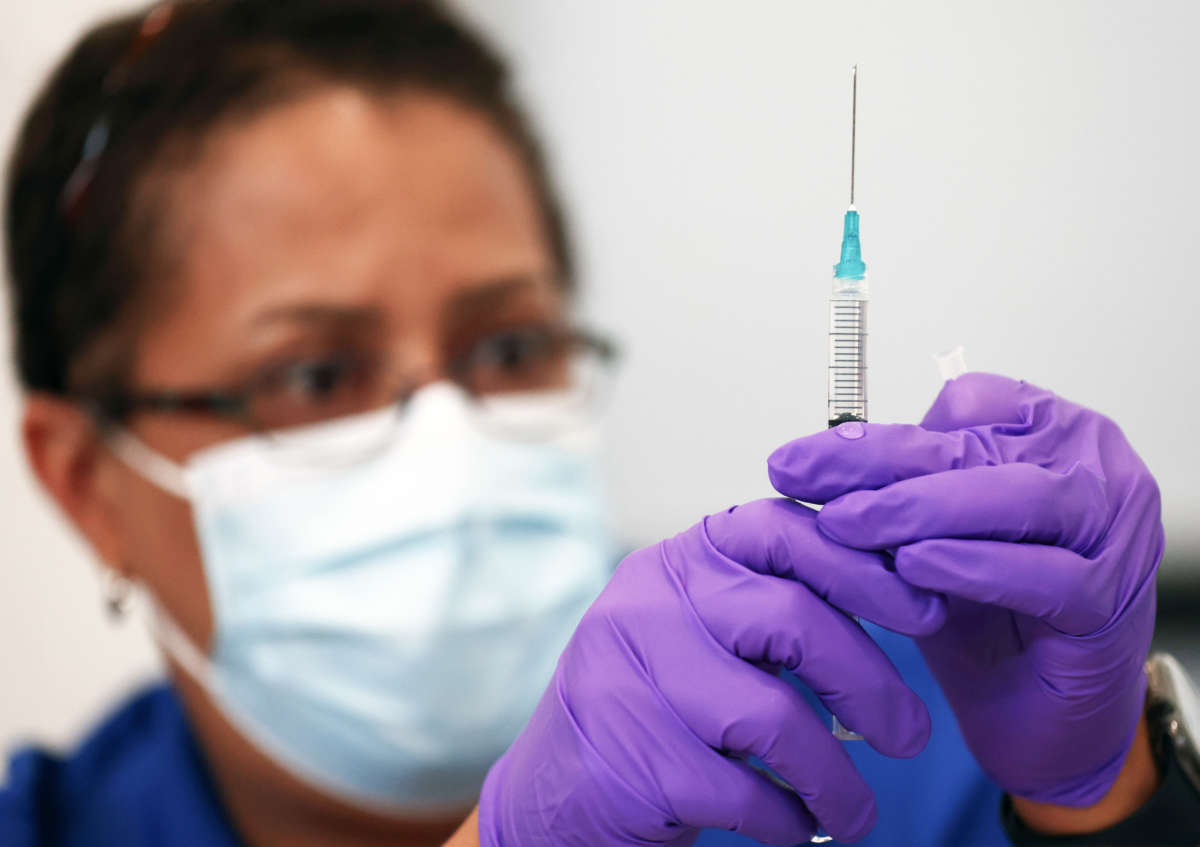 Pharmacist LaChandra McGowan prepares a dose of the Pfizer COVID-19 vaccine at a clinic operated by DePaul Community Health Center on August 12, 2021 in New Orleans, Louisiana.