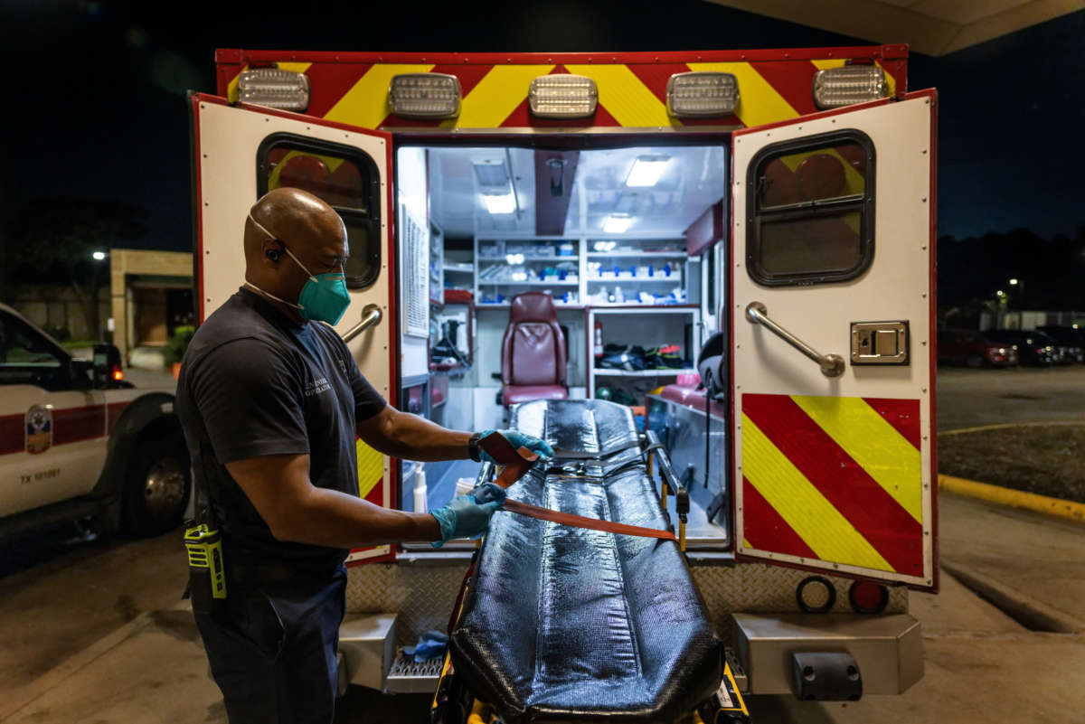 A Houston Fire Department EMS medics disinfect a stretcher after delivering a patient to a Covid-19 overflow area at Memorial Herman Northeast Hospital on August 19, 2021 in Houston, Texas.