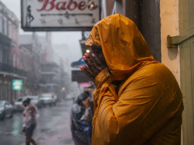 Kandaysha Harris wipes her face before continuing traveling through the storm of Hurricane Ida on August 29, 2021 in New Orleans, Louisiana.