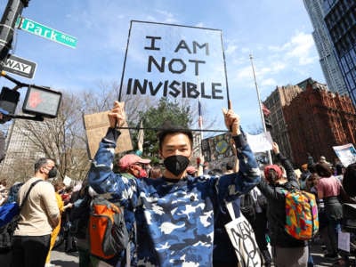 Asian Americans are gathered at the City Hall to protest anti-Asian racism following the Atlanta Spa shooting, in New York City, New York, on March 27, 2021.