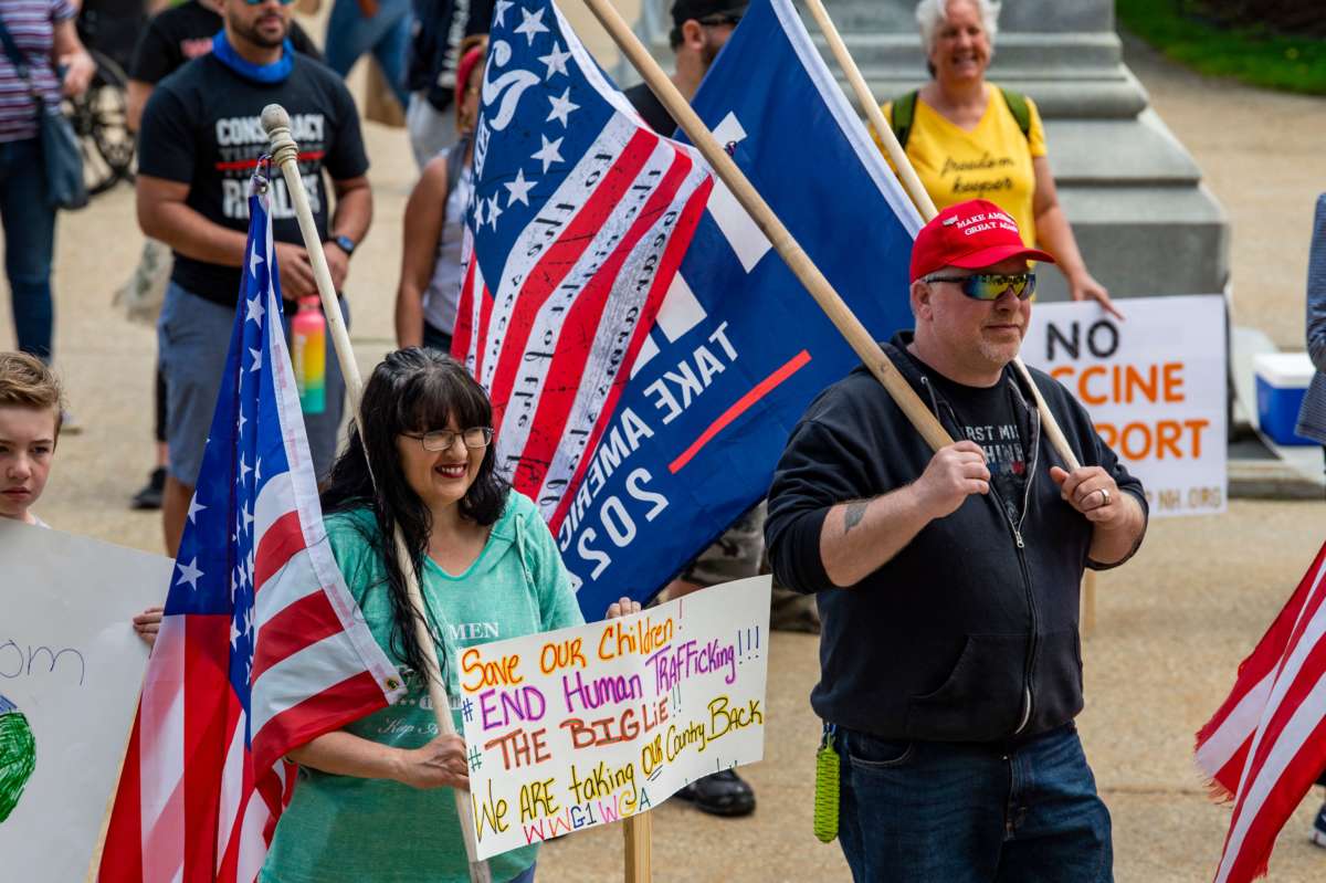 Trump supporters hold signs protesting the current administration at the "World Wide Rally for Freedom," an anti-mask and anti-vaccine rally, at the New Hampshire State House in Concord on May 15, 2021.