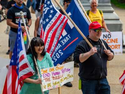 Trump supporters hold signs protesting the current administration at the "World Wide Rally for Freedom," an anti-mask and anti-vaccine rally, at the New Hampshire State House in Concord on May 15, 2021.