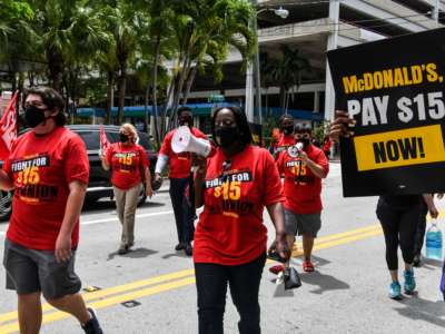 Employees of McDonald's march on the street as they protest for a raise in their minimum wage to $15 an hour, in Fort Lauderdale, Florida, on May 19, 2021.
