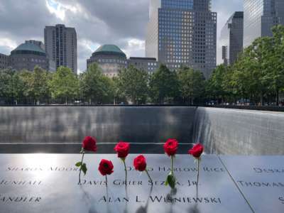 Roses are left in memory of the victims on the 9/11 memorial, in New York City, on July 18, 2021.