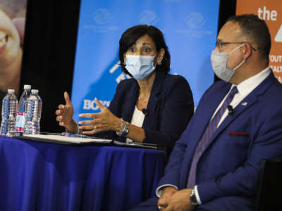 Centers for Disease Control and Prevention Director Rochelle Walensky talks to community members with Education Secretary Miguel Cardona while attending a town hall at the Yawkey Club of Roxbury in Boston, Massachusetts, on August 6, 2021.
