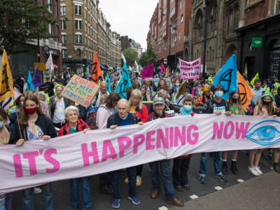 Environmental activists from Extinction Rebellion march from Trafalgar Square during the first day of Impossible Rebellion protests on August, 23, 2021 in London, United Kingdom.