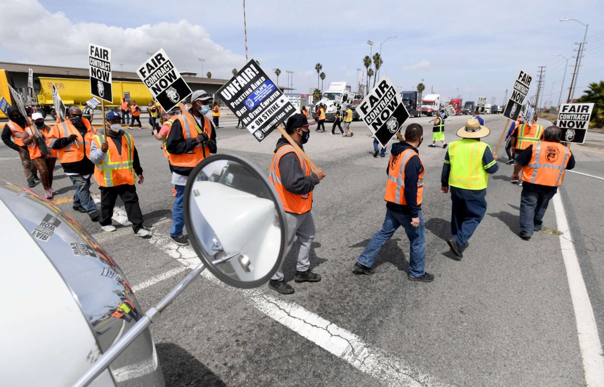 Longshore workers briefly walked off the job on in solidarity with the teamsters to picket and disrupt traffic in San Pedro, California, on April 14, 2021.