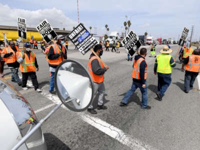 Longshore workers briefly walked off the job on in solidarity with the teamsters to picket and disrupt traffic in San Pedro, California, on April 14, 2021.