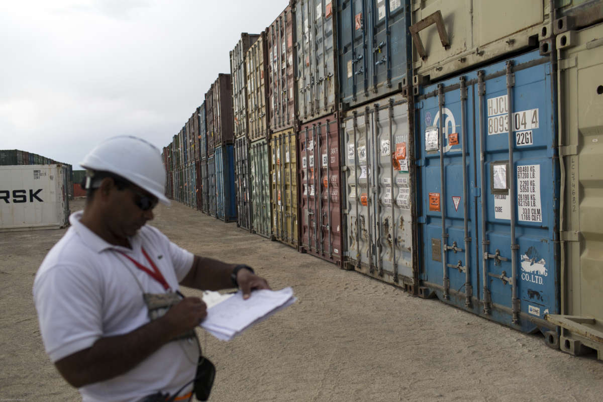 A contractor with the Fluor Corporation takes inventory of containers delivered from U.S. bases that have closed or been turned over to Afghan security forces, on May 4, 2013, at FOB Shank, Afghanistan. The Texas-based defense contractor and construction firm received contracts of at least $85 million this year for work in Afghanistan.