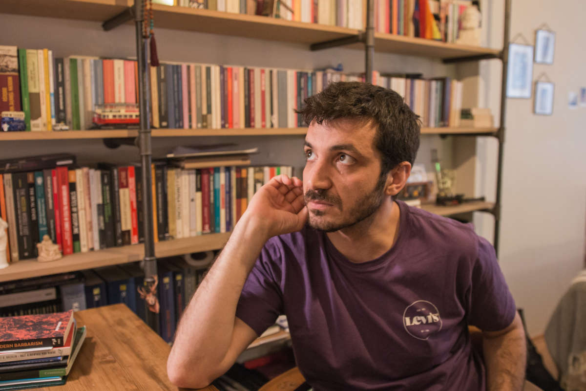 Levent Pişkin sitting in his home office.