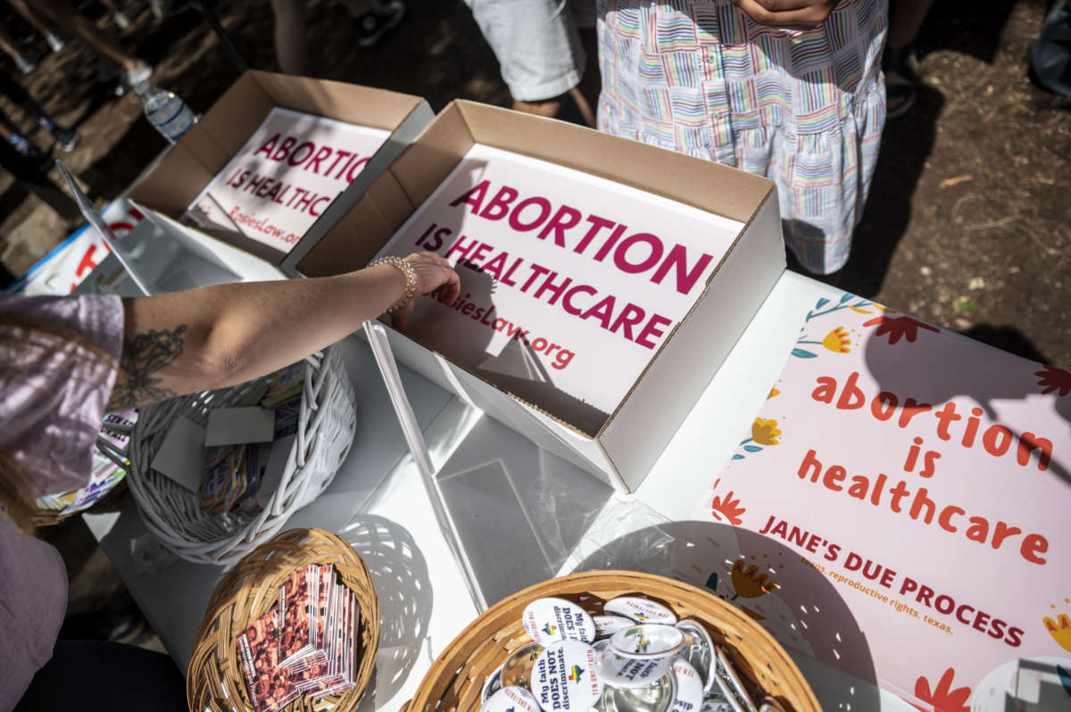 Attendees grab signs at a protest outside the Texas state capitol on May 29, 2021 in Austin, Texas.