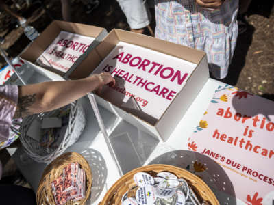 Attendees grab signs at a protest outside the Texas state capitol on May 29, 2021 in Austin, Texas.