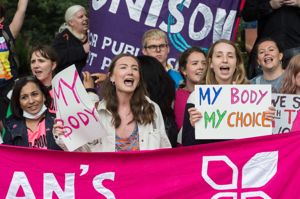 Protesters display signs calling for abortion access