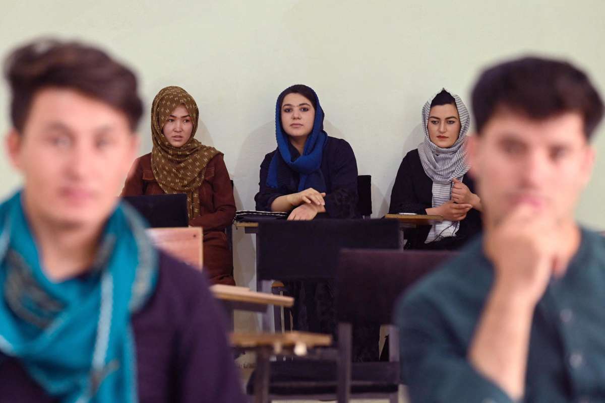 Women in Hijab sit at the back of a classroom