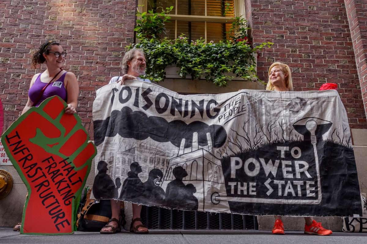 New Yorkers display signs against the continued use of fossil fuels