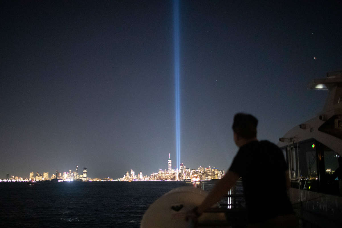 A man looks at the twin towers installation marking the former location of the world trade center buildings