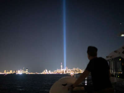 A man looks at the twin towers installation marking the former location of the world trade center buildings
