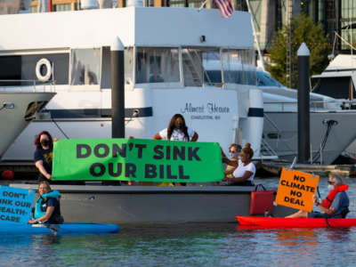A flotilla of activists from Center for Popular Democracy, Court Appointed Special Advocates and Greenpeace USA take to kayaks and electric boats to demonstrate near Sen. Joe Manchin’s houseboat in Washington, D.C. to demand that he support the Build Back Better Act, on September 27, 2021.
