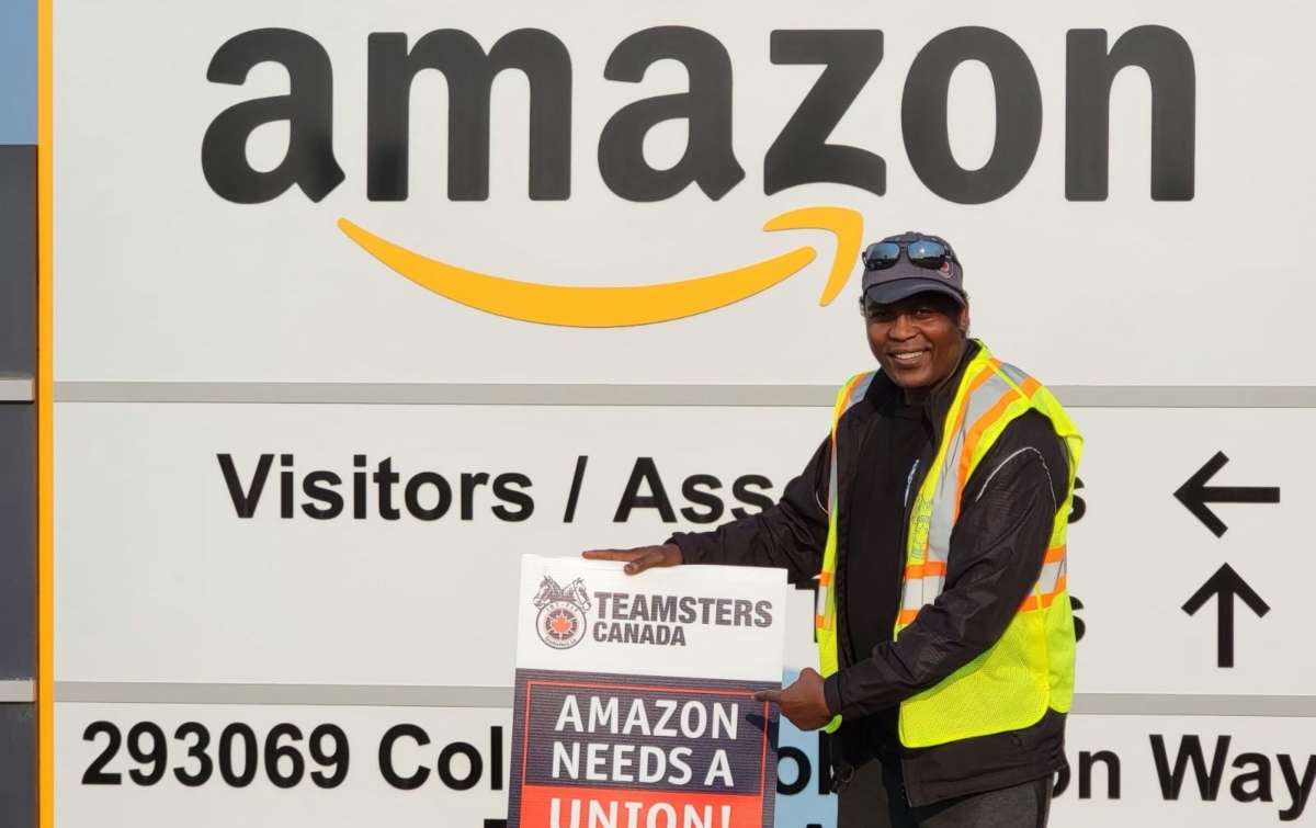 Members of Teamsters Locals 987 and 362 protest outside an Amazon fulfillment center in Alberta, Canada, on July 14, 2021, after meeting with Amazon workers across the country to discuss working conditions and union organizing. 