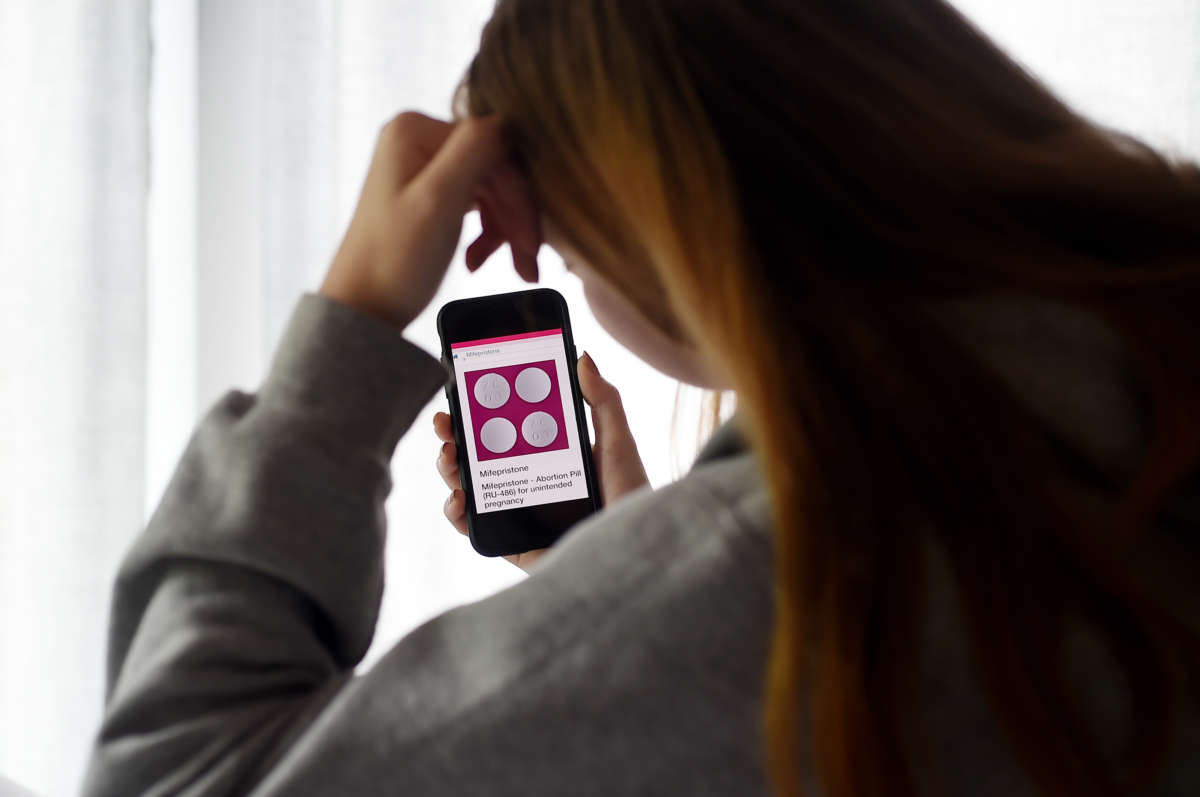 A woman looks at options for the mifepristone abortion pill on May 8, 2020, in Arlington, Virginia, after her home state of Texas temporarily banned abortions in March 2020. Having split with her boyfriend, she decided to buy pills on the internet and perform her own abortion at home.