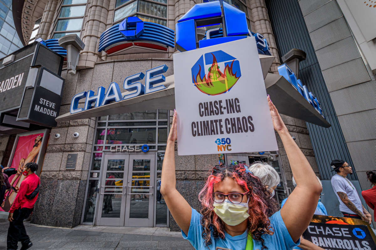Climate activists with Stop the Money Pipeline protest outside Chase Bank branches in midtown Manhattan on June 2, 2021, to demand the banking giant stop investing in fossil fuel projects.
