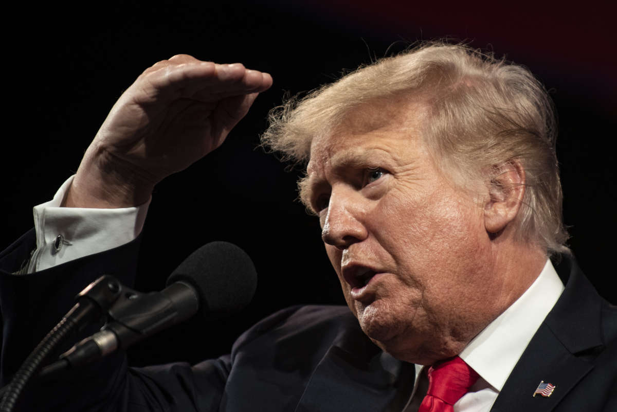 Donald Trump peers at the back of the conference room at television cameras at the Hilton Anatole Hotel in Dallas, Texas, on July 11, 2021.