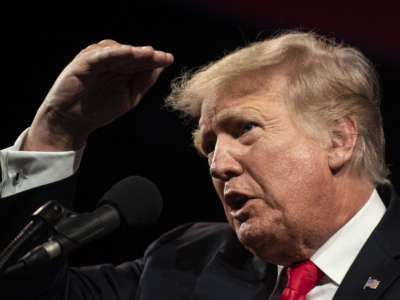 Donald Trump peers at the back of the conference room at television cameras at the Hilton Anatole Hotel in Dallas, Texas, on July 11, 2021.