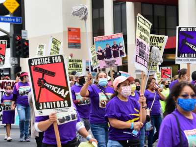 More than 1,000 janitors with the Service Employees International Union (SEIU) rally and march as their contracts expire ahead of a potential strike on September 1, 2021, in Los Angeles, California.