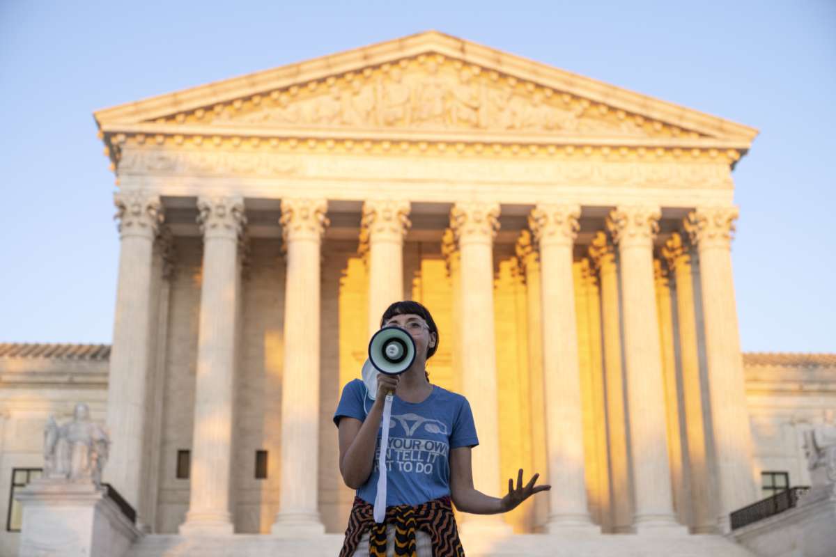 An activist, who declined to provide their name, speaks outside the Supreme Court in protest against the new Texas abortion law that prohibits the procedure around six weeks into a pregnancy on September 2, 2021, in Washington, D.C.