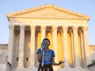 An activist, who declined to provide their name, speaks outside the Supreme Court in protest against the new Texas abortion law that prohibits the procedure around six weeks into a pregnancy on September 2, 2021, in Washington, D.C.