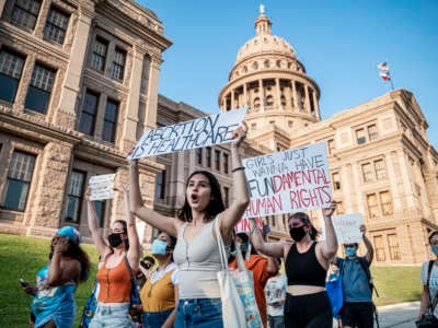 Protesters march outside the Texas State Capitol on September 1, 2021 in Austin, Texas.