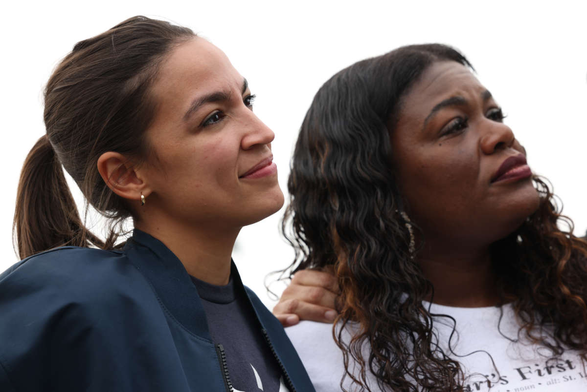 Rep. Alexandria Ocasio-Cortez stands with Rep. Cori Bush during a news conference on the eviction moratorium at the Capitol on August 3, 2021, in Washington, D.C.