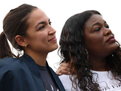 Rep. Alexandria Ocasio-Cortez stands with Rep. Cori Bush during a news conference on the eviction moratorium at the Capitol on August 3, 2021, in Washington, D.C.