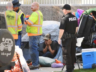 People are evicted from a camp site by Civic Center Park in Denver, Colorado, on September 15, 2021.