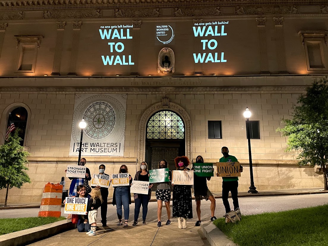 Members of Walters Workers United project their unionization message onto the Walters Art Museum on September 2, 2021, in Baltimore, Maryland.